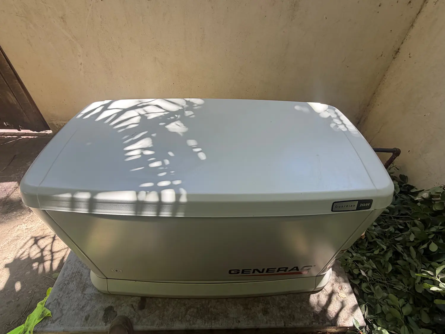 A Generac standby generator installed on its pad beside a Kern County home.